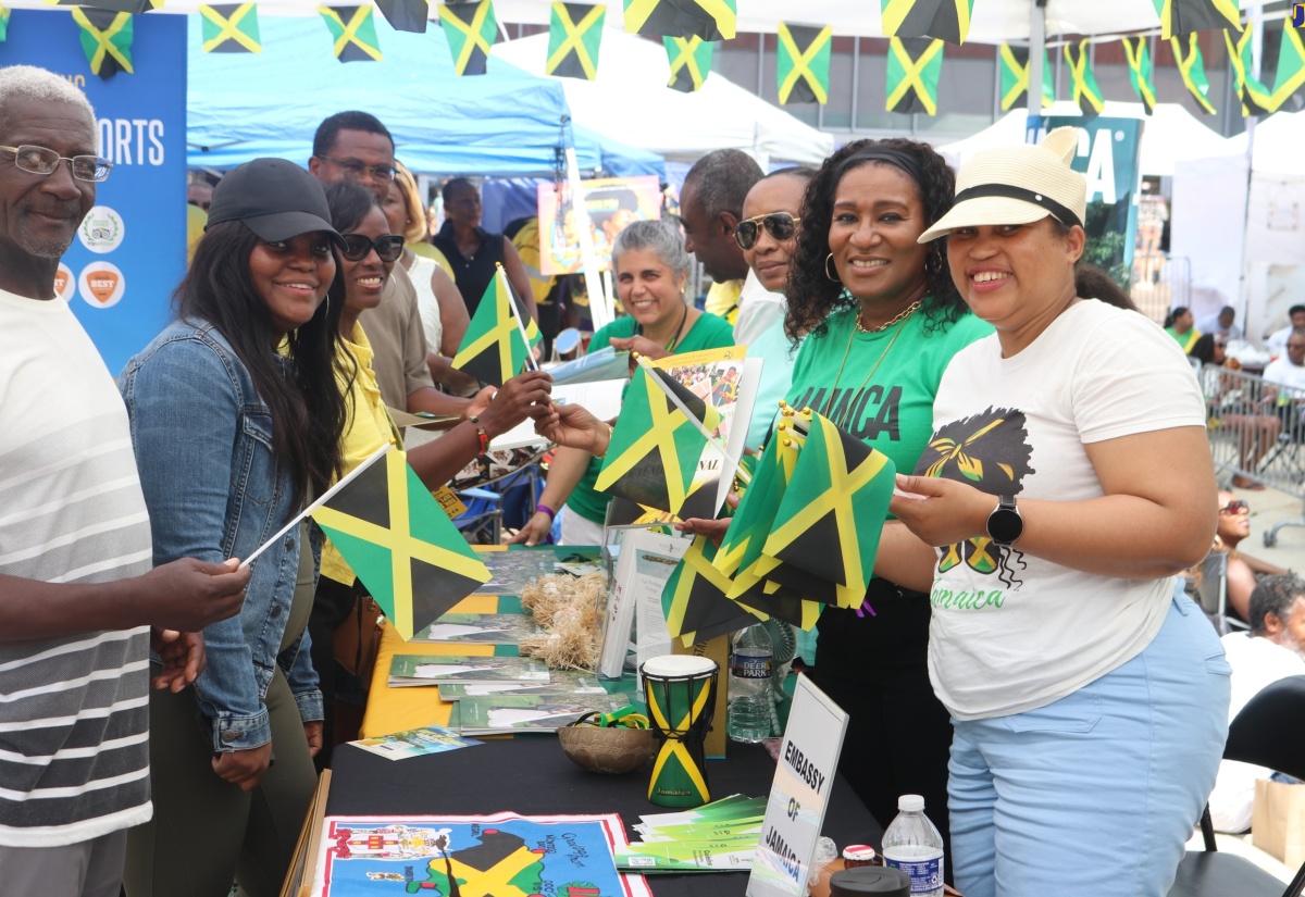 Deputy Chief of Mission at the Embassy of Jamaica in Washington DC, Lishann Salmon (right), along with members of staff, distributes Jamaican flags to persons who visited the Jamaican booth display during the third annual ‘Jamaica Fest’, which was held August 18 at Veterans Plaza in Silver Spring, Maryland.

