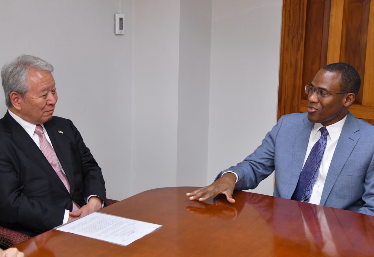 Minister of Finance and the Public Service, Dr. the Hon. Nigel Clarke (right), emphasises a point during a courtesy call by President, Japan International Cooperation Agency (JICA), Dr. Akihiko Tanaka, at the Ministry’s office in Kingston on Wednesday (July 31).