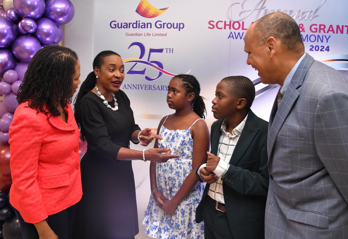 Minister of State in the Ministry of Education and Youth, Hon. Marsha Smith (second left), shares a photo opportunity with the 2024 top Primary Exit Profile (PEP) students and executives of Guardian Group, during Friday’s (August 23) Scholarship & Grant Awards Ceremony, at the Jamaica Pegasus Hotel in New Kingston. Pictured (from left) are President of Guardian Life Limited, Meghon Miller Brown; top PEP girl, Adrianna Cover, and boy, Aiden Cummings; and Guardian Group President, Eric Hosin.