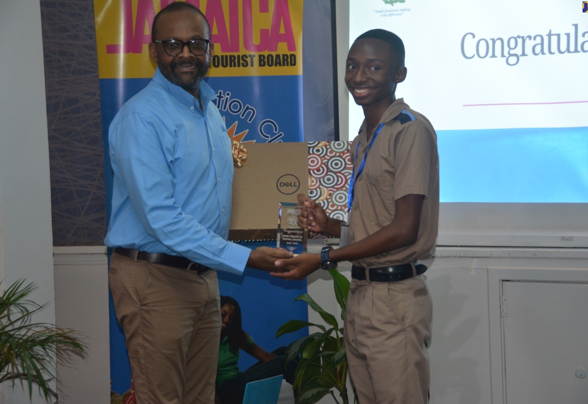 Tourism Director, Donovan White, presents winner of the Jamaica Tourist Board (JTB) 2024/25 Junior Minister of Tourism Competition, 16-year-old student of Manning’s School in Westmoreland, Taj Melbourne, with his prizes following the finals, held recently at Beaches Ocho Rios in Boscobel, St. Mary.