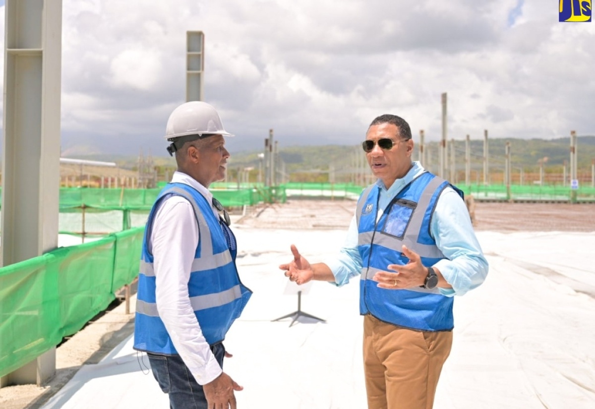 Prime Minister, the Most Hon. Andrew Holness (right), converses with Factories Corporation of Jamaica (FCJ) Chairman, Lyttleton Shirley, during a tour of the Morant Bay Urban Centre earlier this year.

