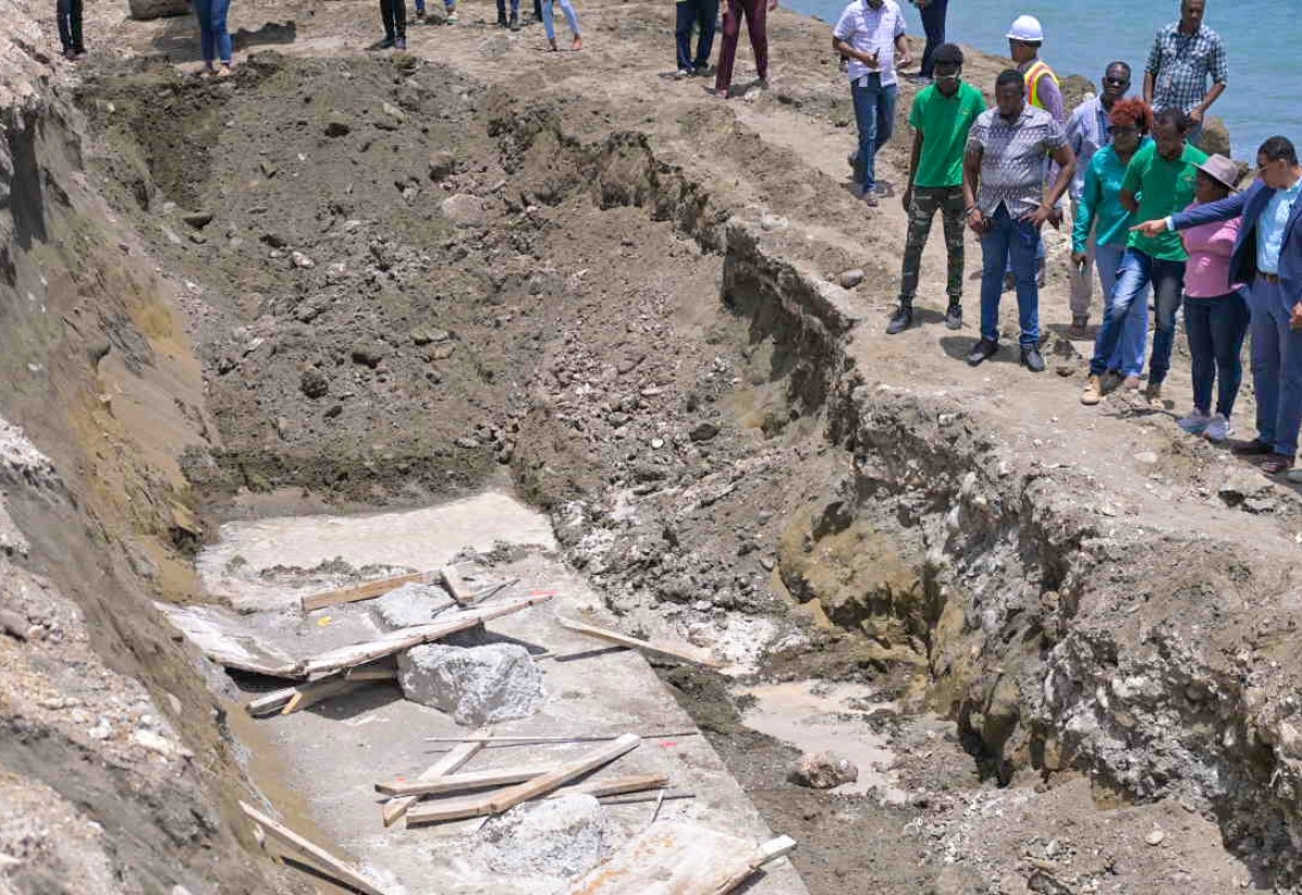 Prime Minister, the Most Hon. Andrew Holness (third left), points to the construction of a sea wall on the Roselle main road, in St. Thomas, during a visit on August 14. Among those looking on are Minister without Portfolio in the Ministry of Economic Growth and Job Creation with responsibility for Works, Hon. Robert Morgan (second left), and Member of Parliament for St. Thomas Western, James Robertson (right).

