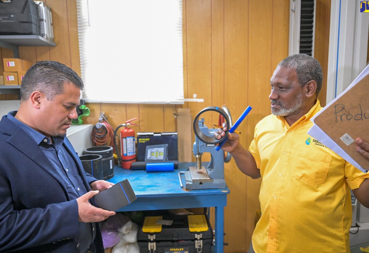 Minister without Portfolio in the Ministry of Economic Growth and Job Creation with Responsibility for Water, Senator the Hon. Matthew Samuda (left), is shown some of the products manufactured by Isratech Jamaica Limited (IJL) by the company’s Quality Manager, Harold Graham. The Minister toured IJL’s Shooter’s Hill headquarters in Manchester on August 23.

