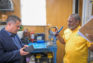 Minister without Portfolio in the Ministry of Economic Growth and Job Creation with Responsibility for Water, Senator the Hon. Matthew Samuda (left), is shown some of the products manufactured by Isratech Jamaica Limited (IJL) by the company’s Quality Manager, Harold Graham. The Minister toured IJL’s Shooter’s Hill headquarters in Manchester on August 23.

