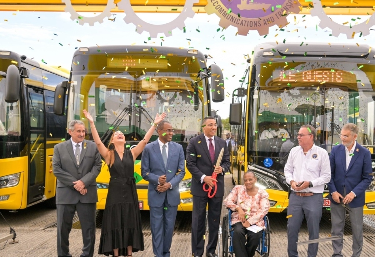 Prime Minister, the Most Hon. Andrew Holness (centre); Minister of Finance and the Public Service, Dr. the Hon. Nigel Clarke (third left); and Minister of Science, Energy, Telecommunications and Transport, Hon. Daryl Vaz (third right), celebrate the addition of 100 new compressed natural gas (CNG) buses to the Jamaica Urban Transit Company (JUTC) fleet, at the recent handover ceremony at the Portmore Depot, in St. Catherine. Sharing the moment are (from left): JUTC Managing Director, Paul Abrahams; Member of Parliament, Portland Eastern, Ann-Marie Vaz; President, Combined Disabilities Association, Christine Keene; and JUTC Chairman, Russell Hadeed.