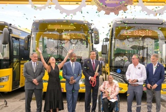 Prime Minister, the Most Hon. Andrew Holness (centre); Minister of Finance and the Public Service, Dr. the Hon. Nigel Clarke (third left); and Minister of Science, Energy, Telecommunications and Transport, Hon. Daryl Vaz (third right), celebrate the addition of 100 new compressed natural gas (CNG) buses to the Jamaica Urban Transit Company (JUTC) fleet, at the recent handover ceremony at the Portmore Depot, in St. Catherine. Sharing the moment are (from left): JUTC Managing Director, Paul Abrahams; Member of Parliament, Portland Eastern, Ann-Marie Vaz; President, Combined Disabilities Association, Christine Keene; and JUTC Chairman, Russell Hadeed.