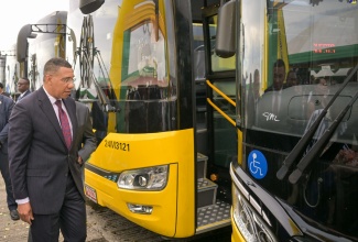 Prime Minister, the Most Hon. Andrew Holness, examines one of the new compressed natural gas (CNG) buses acquired for the Jamaica Urban Transit Company (JUTC) during Tuesday’s (August 27) handover ceremony at the State entity’s Portmore Depot in St. Catherine.

