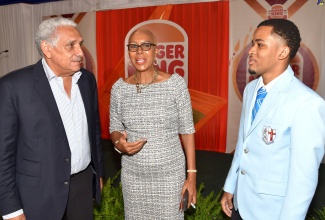 Minister of Education and Youth, Hon. Fayval Williams, speaks with 2024 Burger King Scholarship awardee, Janoy McRae (right), and Group Chairman, Restaurants Associates Limited, Richard Lake, during the recent scholarship awards presentation ceremony at the Terra Nova All-Suite Hotel in St. Andrew.

