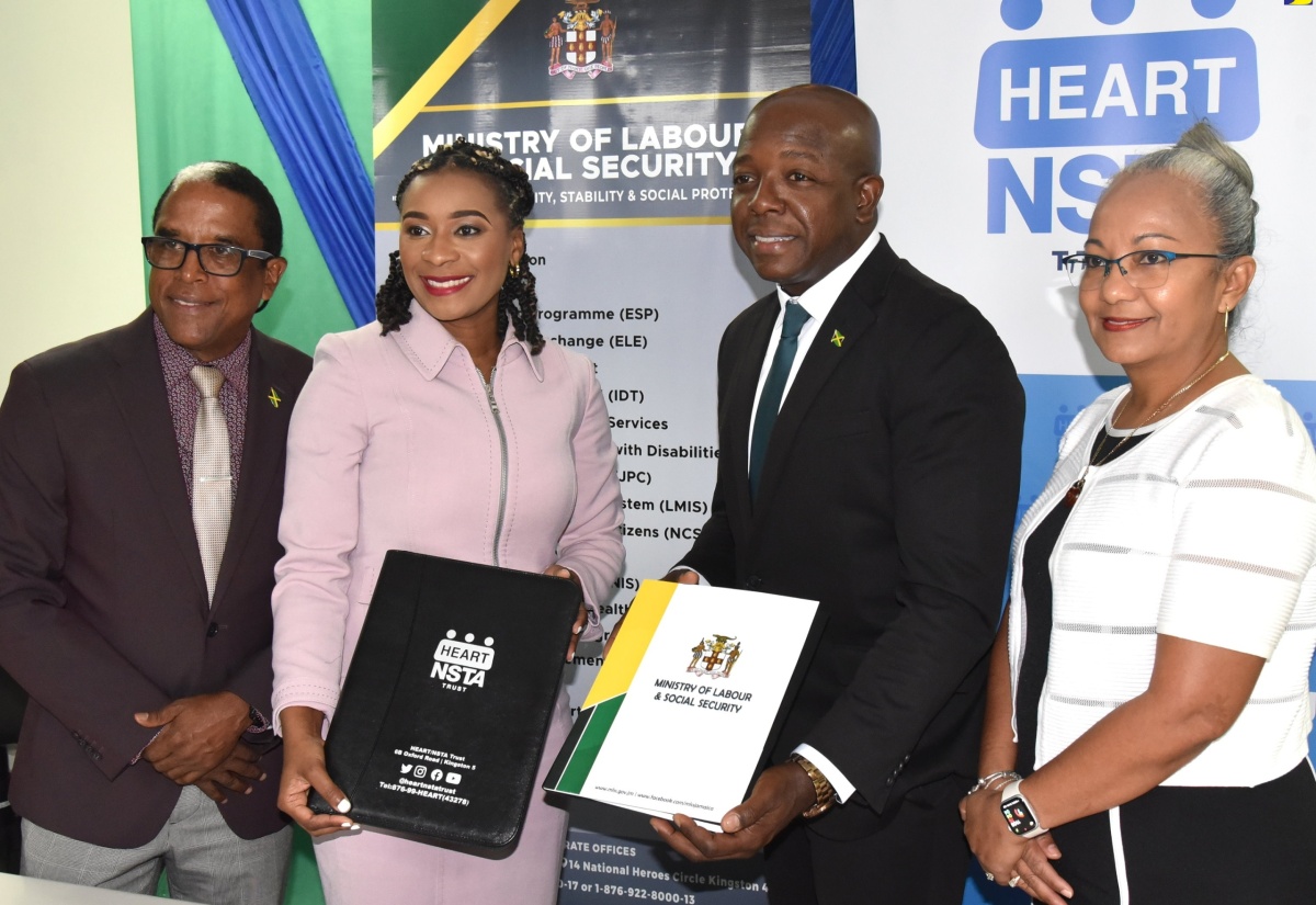 Minister of Labour and Social Security, Hon. Pearnel Charles Jr (second right) and Managing Director of the HEART/NSTA Trust, Dr. Taneisha Ingleton (second left), display copies of the Memorandum of Understanding (MOU) between the entities, which is aimed at enhancing the Overseas Employment Programme. The signing took place at the Ministry’s North Street offices in Kingston on Friday (July 26). Sharing the moment are State Minister, Dr. the Hon. Norman Dunn and Permanent Secretary in the Ministry, Colette Roberts Risden. The agreement aims to foster a robust and dynamic labour market by equipping workers with employment readiness training and other skillsets required to succeed in the local and global workspace.

