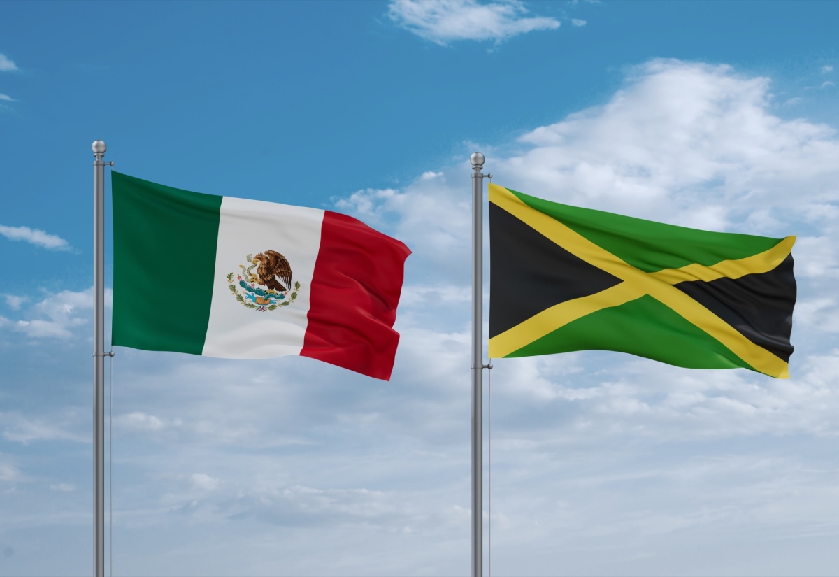 Jamaica and Mexico flags waving together in the wind. 