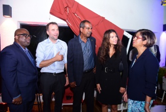 Permanent Secretary in the Ministry of Industry, Investment and Commerce, Sancia Bennett Templer (right), is in discussion with (from left) Chief Executive Officer, Nation’s Choice, Donald McDonald;  Norwegian Seafood Council (NSC) Director for the Caribbean and Mexico, Orjan Olsen; Chief Executive Officer, National Fisheries Authority, Dr. Gavin Bellamy and Counselor for the NSC, Susanne Karine Gjonnes. Occasion was the NSC’s Social Event, themed: 'A Tasteful Exchange: Norway Meets Jamaica,' on Thursday (Sept. 12) at the ROK Hotel in downtown Kingston.