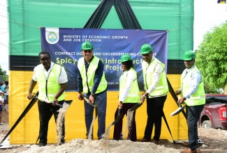 Prime Minister, Dr. the Most Hon. Andrew Holness (second left), officially breaks ground for the Spicy Grove Infrastructure Works Project in Oracabessa, St. Mary, on Wednesday (September 25). Also participating are (from left) Member of Parliament for St. Mary Western, Robert Montague; Permanent Secretary in the Ministry of Economic Growth and Job Creation, Arlene Williams (second right); Mayor of Port Maria, Councillor Fitzroy Wilson, and Managing Director for Southland Construction Limited, which will undertake the project, Raynard Hudlin.

