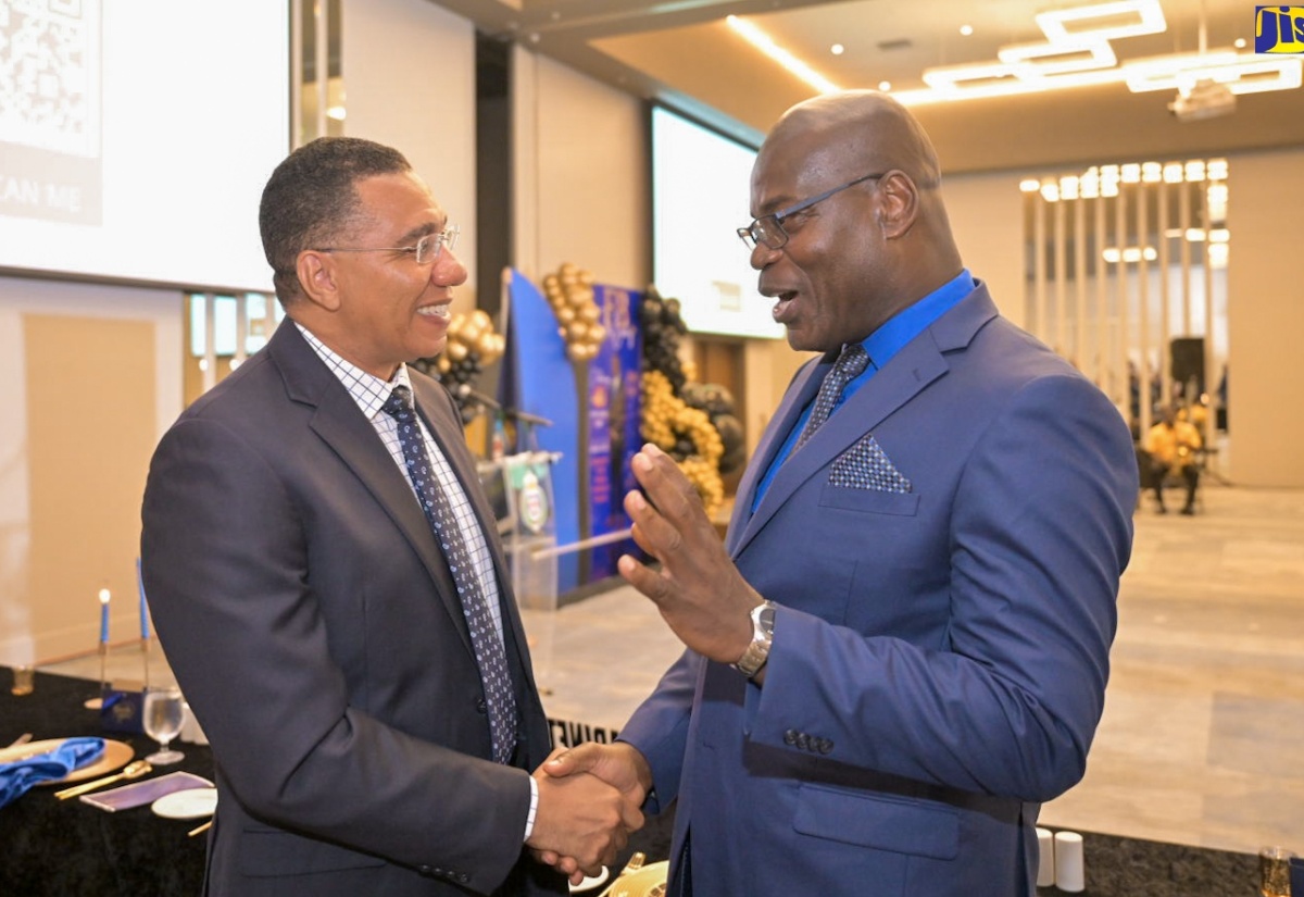 Prime Minister, the Most Hon. Andrew Holness (left), engages in conversation with outgoing Deputy Commissioner of Police (DCP) Fitz Bailey, at a retirement function for the veteran policeman, held on Friday (September 6), at the AC Mariott Hotel, in New Kingston.