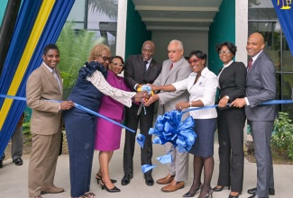 Minister of Justice, Hon Delroy Chuck (fourth right) and Chief Justice, Hon. Mr. Justice Bryan Sykes (fourth left), cut the ribbon to officially hand over the renovated St. Ann Family Court building to the Court Administration Division (CAD), on Wednesday (September 4), in St. Ann’s Bay.  Also taking part are (from left) Judge of the Court of Appeal, Justice Davis Fraser; Custos of St. Ann, Hon. Norma Walters; Permanent Secretary in the Justice Ministry, Grace Ann Stewart McFarlane; Chief Executive Officer of the CAD, Tricia Cameron Anglin; Senior Parish Court Judge, Her Hon. Mrs. Yvette Wentworth-Miller, and Chief Judge of Parish Courts, His Honour Chester Crooks.

