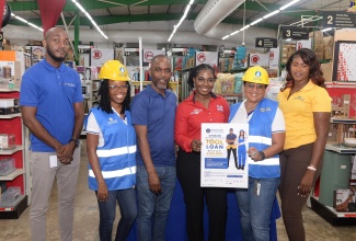 Business Development Executive, Development Bank of Jamaica (DBJ), Christine Bernard (second right) and Marketing Officer at Hi-Pro, Le-Anna Webster (third right), display a poster promoting the DBJ’s Tradesperson Ownership Opportunity Loan (TOOL) Programme, during a TOOL Roadshow stop at Hi-Pro in White Marl, St. Catherine, on Wednesday (September 11). Sharing the moment (from left) are Loan Officer at Regions Financial Services, Lamardo Goodrich; Relationship Executive, DBJ, Nickesha Barrett; Business Origination and Development Manager, EXIM Bank, Hopeton Nicholson; and Operations Manager, Bull Investments, Nickosha Higgins.

