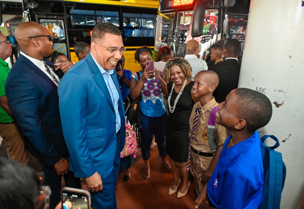 Prime Minister, the Most Hon. Andrew Holness (third left), speaks with Kingston College and Jamaica College students on Monday’s (September 2) start of the 2024/25 academic year. Looking on is Minister without Portfolio in the Office of the Prime Minister with Responsibility for Information, Skills and Digital Transformation, Senator Dr. the Hon. Dana Morris Dixon (third right). The Prime Minister and several Government Ministers greeted students at the Half-Way Tree Transport Centre in St. Andrew as they made their way to school.

