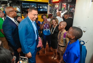 Prime Minister, the Most Hon. Andrew Holness (third left), speaks with Kingston College and Jamaica College students on Monday’s (September 2) start of the 2024/25 academic year. Looking on is Minister without Portfolio in the Office of the Prime Minister with Responsibility for Information, Skills and Digital Transformation, Senator Dr. the Hon. Dana Morris Dixon (third right). The Prime Minister and several Government Ministers greeted students at the Half-Way Tree Transport Centre in St. Andrew as they made their way to school.

