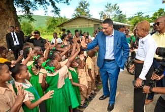 Prime Minister, the Most Hon Andrew Holness, gives a ‘high five’ to students of the Hope Valley Experimental School in St. Andrew. Looking on is Education and Youth Minister, the Most Hon. Fayval Williams. Prime Minister Holness and Minister Williams visited with students, staff, and parents at the school in St. Andrew, during Monday’s (September 2) start of the 2024/25 academic year.

