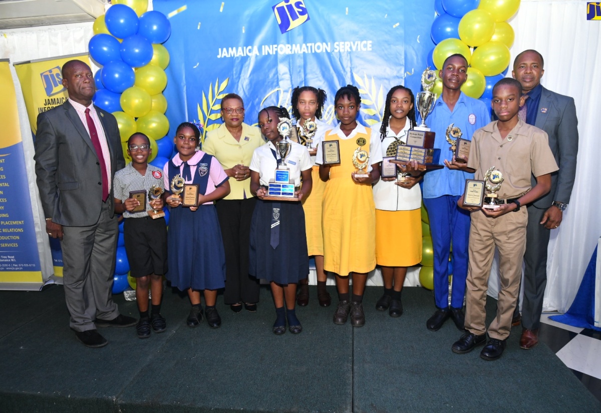 Chief Executive Officer of the Jamaica Information Service (JIS), Enthrose Campbell (fourth left); Director of Corporate Services at the JIS, Errol Gardner (left) and Director of Human Resources at the JIS, Dr. David Knight, celebrate with the JIS Heritage Competition 2023 winners representing (from left) Bright Beginnings Education Centre, Richmond Primary and Infant School, Grove Town Primary, York Castle High, José Martí High and Cornwall College.

