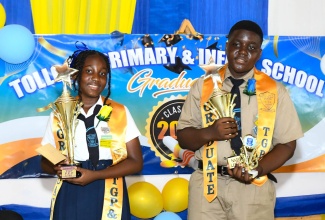 Top student at Toll Gate Primary and Infant School in Clarendon, Aalliyah Pinnock (left), and top boy, Damion Cambell, display their trophies during the recent graduation ceremony at the Assemblies of the First Born Church International, in Decoy, in the parish.

