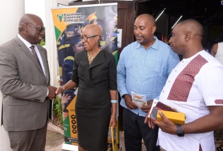 Minister of Education and Youth, Hon. Fayval Williams, greets Excelsior Community College Principal, Philmore McCarthy, during the institution’s 50th anniversary church service on Sunday (September 22). The service was held at Vineyard Town Methodist Church in Kingston. With them are: Member of Parliament for St. Andrew South Eastern, Julian Robinson (second right); and Mayor of Kingston, Councillor Andrew Swaby.

