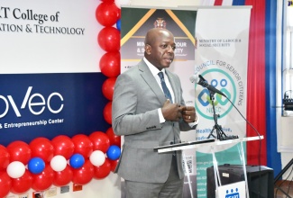 Minister of Labour and Social Security, Hon. Pearnel Charles Jr., addresses the graduation ceremony of the National Council for Senior Citizens (NCSC) Digital Literacy training programme, which was held at the HEART College of Innovation and Technology in St. James, recently.

