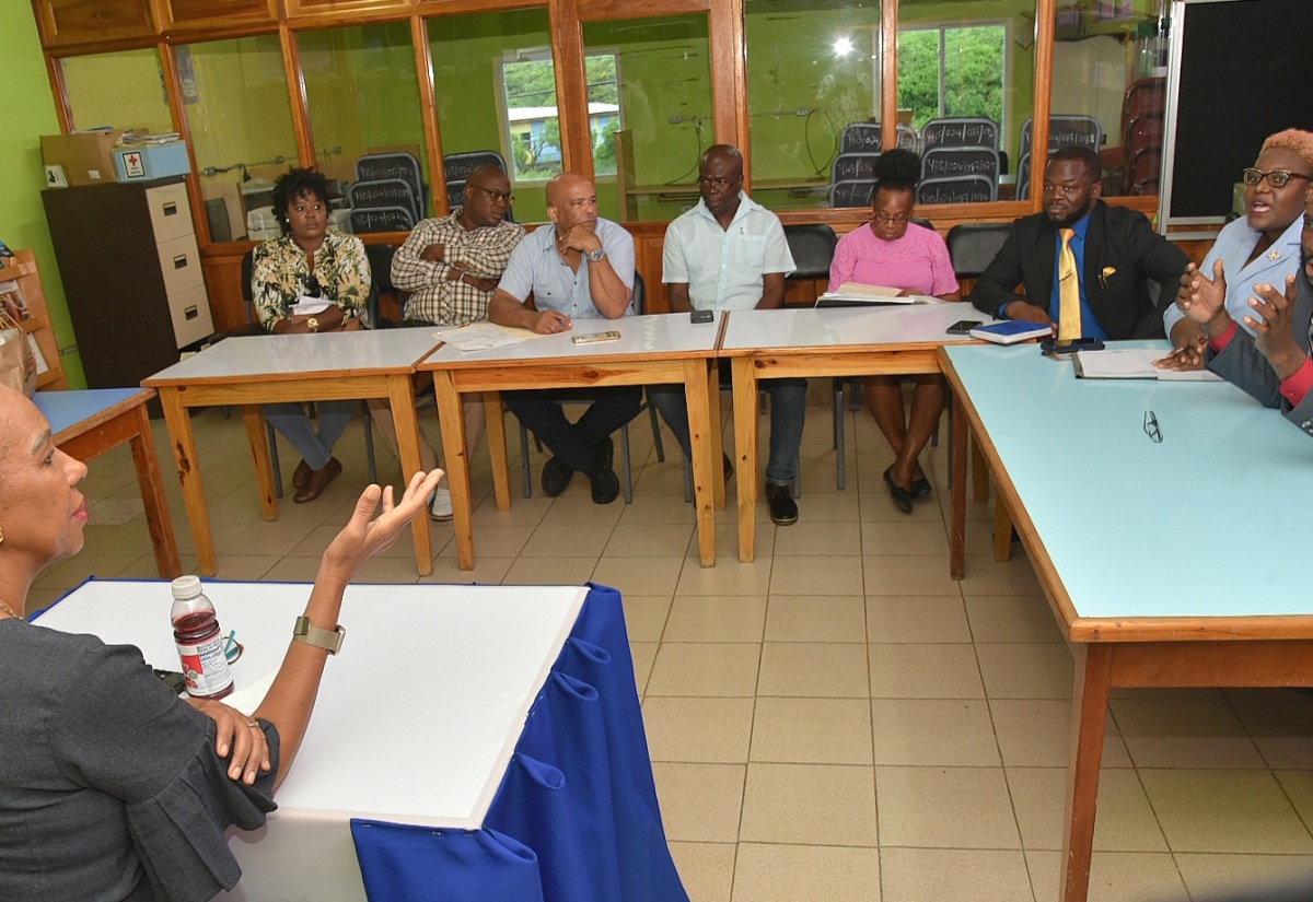 Minister of Education and Youth, Hon. Fayval Williams (foreground), is briefed on developments at Yallahs High School in St. Thomas by Principal, Mark Malabver, during a meeting with members of the institution’s leadership on Wednesday (September 4). Also listening is Member of Parliament for St. Thomas Western, James Robertson (third left).

