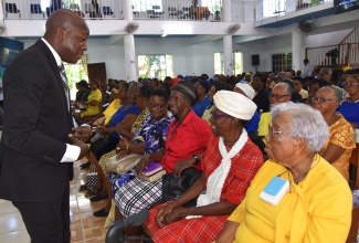 Minister of Labour and Social Security, Hon. Pearnel Charles Jr. (left), interacts with senior citizens during the National Thanksgiving Church Service to mark Senior Citizens' Month 2024, held at the Port Maria Seventh-day Adventist (SDA) Church in St. Mary on Saturday, September 14.

