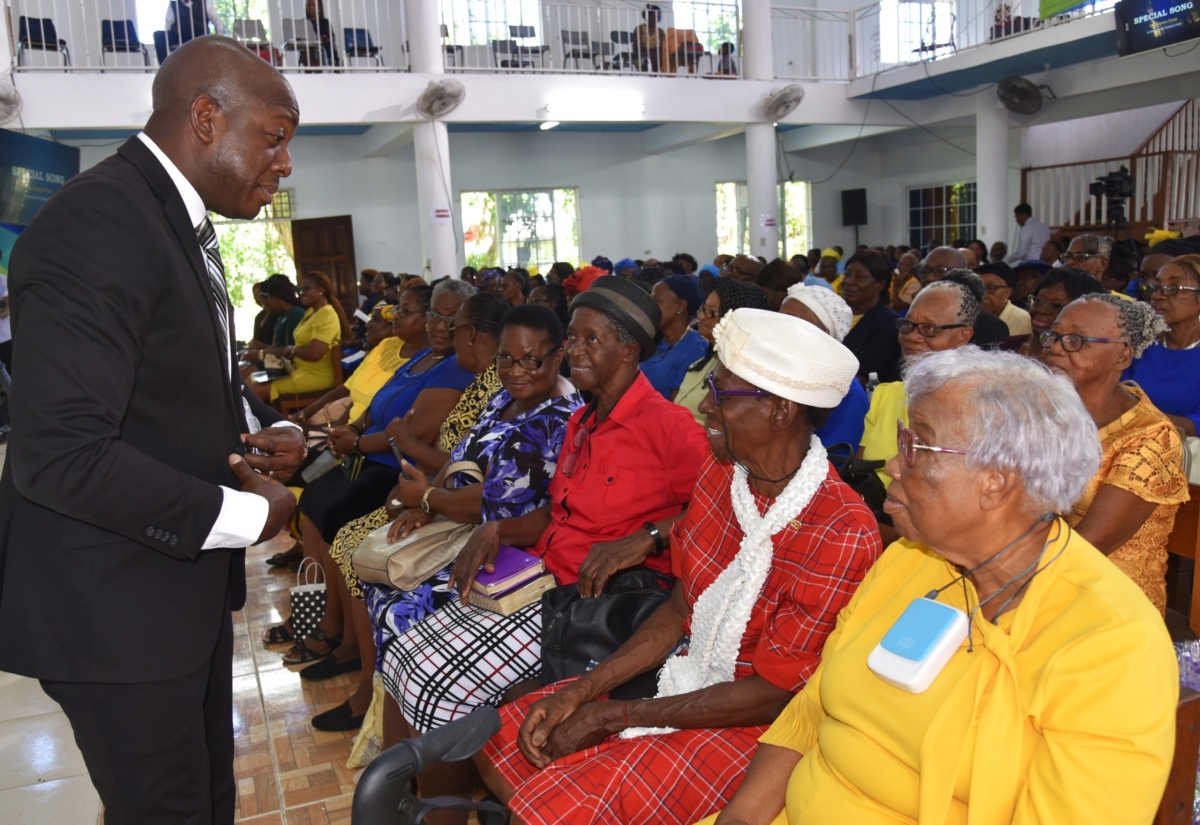  Minister of Labour and Social Security, Hon. Pearnel Charles Jr.  (left), engages with senior citizens at the National Thanksgiving Church Service in observance of Senior Citizens' Month 2024 at the Port Maria Seventh Day Adventist (SDA) Church in St. Mary on Saturday (Sept. 14). 