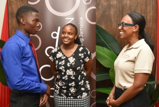 Chief Executive Officer of National Rums of Jamaica (NRJ), Martha Miller (right), engages with NRJ Foundation scholarship recipients, Demario Johnson (left) and Anuscha Hurst. The event was the Foundation’s inaugural scholarship award ceremony on Friday (Sept. 13), at NRJ, 3 Ardenne Road, St. Andrew.