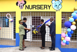 State Minister in the Ministry of National Security, Hon Juliet Cuthbert-Flynn (second right), is assisted by (from left) Superintendent, South Camp Adult Correctional Centre, Joycelyn Roach Spencer; Permanent Secretary in the Ministry, Ambassador Alison Stone Roofe; and Commissioner of Corrections, Brigadier (Ret'd) Radgh Mason, in cutting the ribbon to officially open a newly built infant nursery for incarcerated expectant mothers and their babies, on Tuesday (September 24). The nursery is located at the South Camp Adult Correctional Centre in Kingston.

