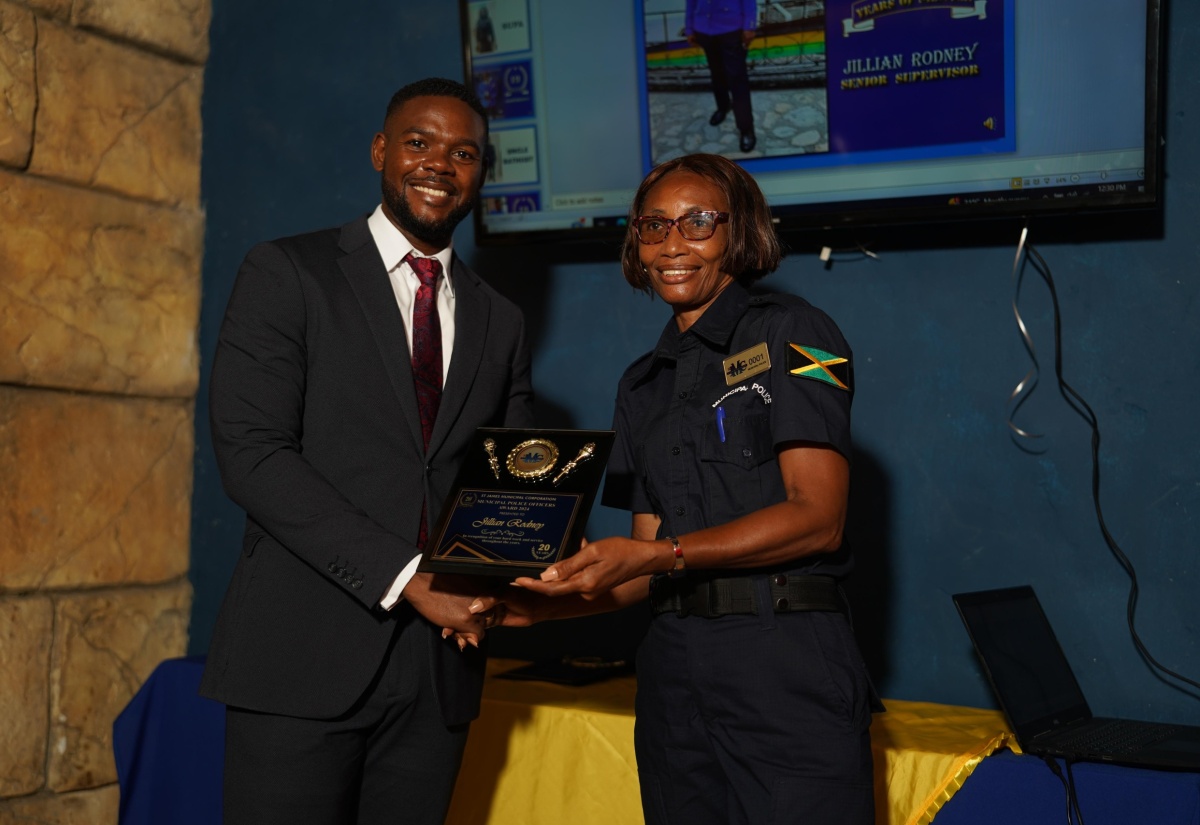 Supervisor, St. James Municipal Corporation Police Unit, Jillian Rodney, accepts the Municipal Police Officers 2024 Award from Mayor of Montego Bay and Chairman of the St James Municipal Corporation, Councillor Richard Vernon, in honour of her 20 years of dedicated service.

