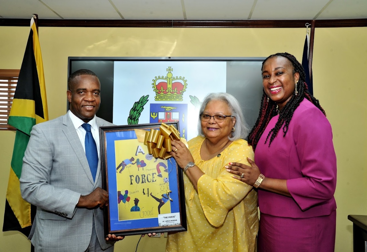 Commissioner of Police, Dr. Kevin Blake (left), sharing lens time with PCOA representatives, Chairman, Jacqueline Hinkson (centre) and PCOA CEO, Otarah Byfield Nugent, after receiving a framed artwork, titled 'The Force' by Westwood High School student, Adeija McBean, who won first place in the TOPS Poster Competition for high schools in Area 2 (St. Ann, St. Mary and Portland) in 2023.

