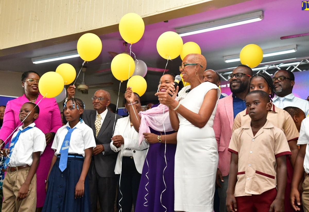 Minister of Education and Youth, Hon. Fayval Williams (second right), addresses the audience at the official launch of the new school year, at Clarendon College, on September 17. With the Minister (third right) is Permanent Secretary in the Ministry, Dr. Kasan Troupe.

