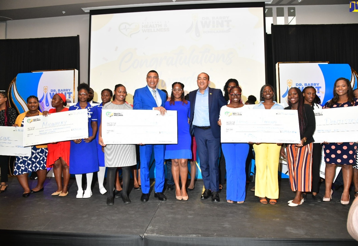 Prime Minister, the Most Hon. Andrew Holness (sixth left), and Minister of Health and Wellness, Dr. the Hon. Christopher Tufton (eighth left), with some of the more than 500 recipients who received the Dr. Barry Wint Memorial Scholarship, at a ceremony held today (August 30), at the AC Mariott Hotel, in New Kingston.

