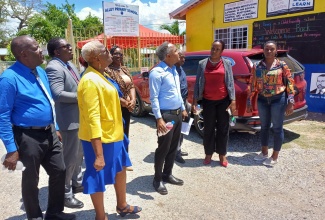 Principal of Alley Primary School in Clarendon, Judith Richards (third left), and Chairman, Junior Maragh (fourth right), are accompanied by senior personnel from the Ministry of Education and Youth, and other officials of the institution in viewing a newly built roof at the school on Tuesday (September 3). The new roof replaces the previous structure, which was severely damaged during Hurricane Beryl’s passage, just south of Jamaica, on July 3.

