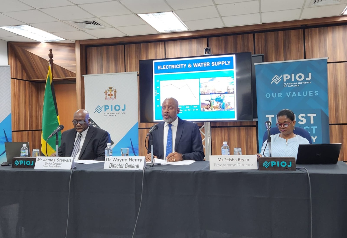 Director General, Planning Institute of Jamaica (PIOJ), Dr. Wayne Henry (centre), speaks during the agency’s June 2024 quarterly media briefing on Wednesday (September 4). Listening (from left) are PIOJ Senior Director, Economic Planning and Research, James Stewart; and Vision 2030 Jamaica Programme Director, Peisha Bryan Lee.

