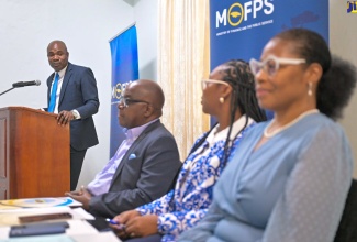 State Minister in the Ministry of Finance and the Public Service, Hon. Zavia Mayne (left), addresses Tuesday’s (September 24) industrial relations practitioners seminar at the Medallion Hall Hotel in Kingston. Listening (from second left) are Acting Financial Secretary, Ministry of Finance and the Public Service, Wayne Jones; Jamaica Civil Service Association (JCSA) President, Techa Clarke-Griffiths, and Executive Director, Transformation Implementation Unit (TIU), Maria Thompson Walters.

