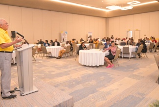 Justice Minister, Hon. Delroy Chuck, addresses Justices of the Peace (JPs) in Kingston during the Ministry's sensitisation session on Wednesday (September 25) at the AC Marriott Hotel.

