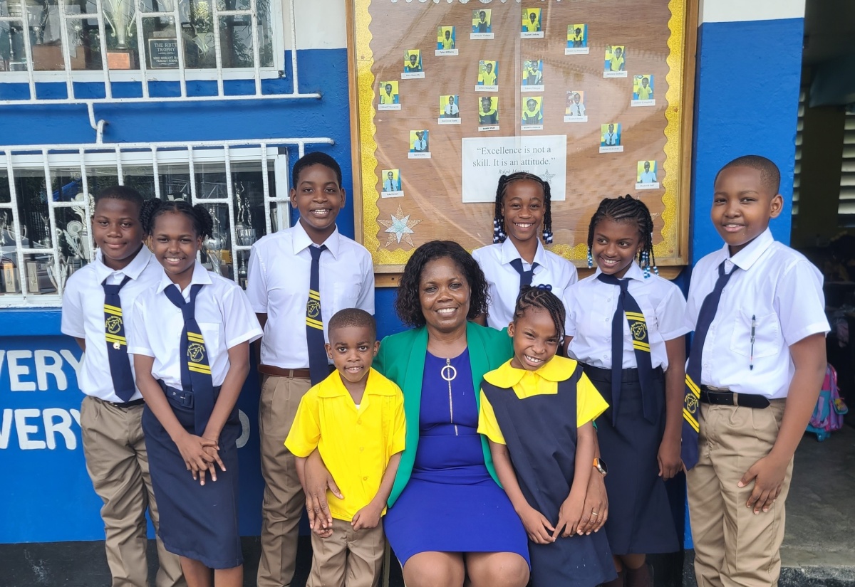 Nestled among her pupils is Principal of the Morant Bay Primary School, Fay Lindsay.

