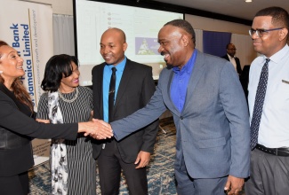 Managing Director at Leve Global, Dr. Auliana Poon (left), greets General Manager, Trade & Commercial Lending, EXIM Bank, Winston Lawson (second right), at a National Consultation and Validation Workshop held on Tuesday (September 17) at The Jamaica Pegasus hotel in New Kingston. Others (from left) are General Manager, Strategic Services Division, DBJ, Deborah Newland; Assistant General Manager, Lasco Microfinance Limited, Ricardo Thomas; and Administrator, Newport Medical Group, Dennis Chen.

