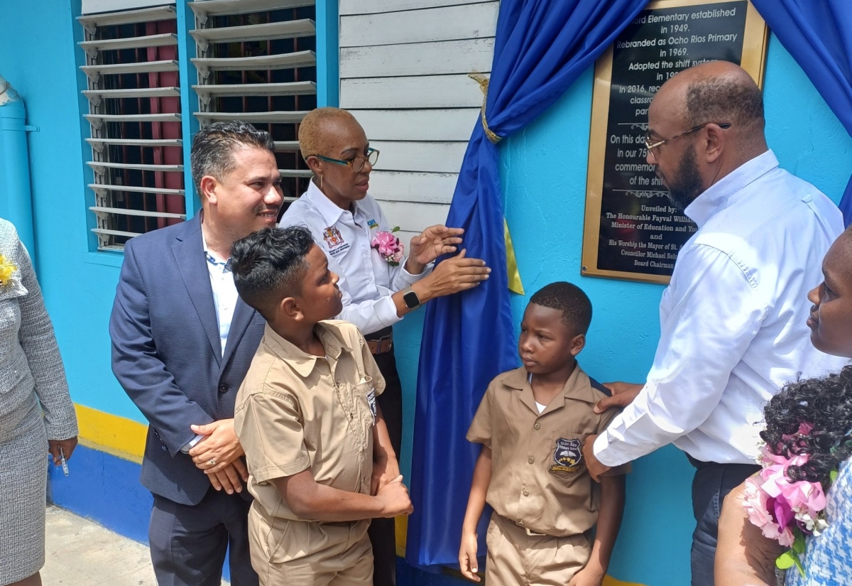 Minister of Education and Youth, Hon. Fayval Williams (second left), inspects a plaque on the wall on opening day of the 2024/2025 school year at the Ocho Rios Primary School in St. Ann on September 2. At left is Minister without Portfolio in the Ministry of Economic Growth and Job Creation, Senator the Hon Matthew Samuda, and at right is Mayor of St. Ann’s Bay, Councillor Michael Belnavis.   

