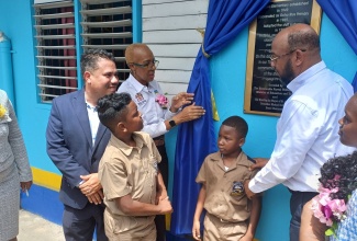 Minister of Education and Youth, Hon. Fayval Williams (second left), inspects a plaque on the wall on opening day of the 2024/2025 school year at the Ocho Rios Primary School in St. Ann on September 2. At left is Minister without Portfolio in the Ministry of Economic Growth and Job Creation, Senator the Hon Matthew Samuda, and at right is Mayor of St. Ann’s Bay, Councillor Michael Belnavis.   

