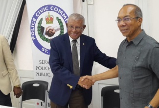 Deputy Prime Minister and Minister of National Security, Hon. Dr. Horace Chang (right), is greeted by Chairman, St James Police Civic Committee, Dr. Lee Bailey, on his arrival at the St. James Police Civic Committee meeting, held at the Montego Bay Yacht Club in Freeport, St. James, on August 29. 
