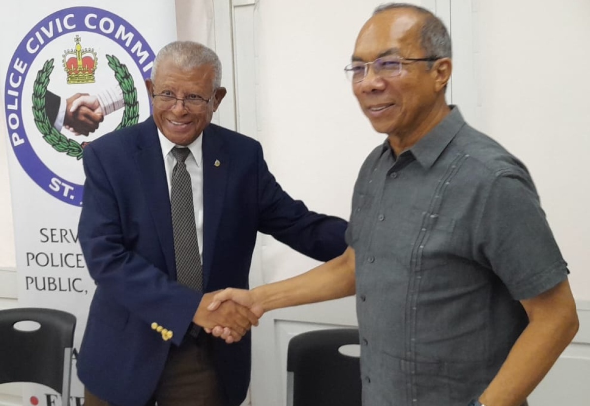 Deputy Prime Minister and Minister of National Security, Hon. Dr. Horace Chang (right), is greeted by Chairman, St James Police Civic Committee, Dr. Lee Bailey, on his arrival at the St. James Police Civic Committee meeting, held at the Montego Bay Yacht Club in Freeport, St. James, on August 29. 
