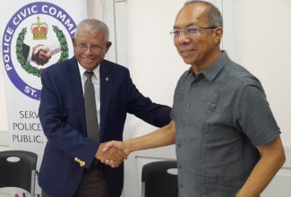 Deputy Prime Minister and Minister of National Security, Hon. Dr. Horace Chang (right), is greeted by Chairman, St James Police Civic Committee, Dr. Lee Bailey, on his arrival at the St. James Police Civic Committee meeting, held at the Montego Bay Yacht Club in Freeport, St. James, on August 29. 
