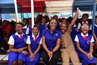  Acting Special Projects Manager at the Jamaica Information Service (JIS), Charnele Henry (seated, centre) shares a light moment with students from Lannaman’s Preparatory School (seated from left) Sabia Smellie, Tanice Barrett, Nosal Wilson, Malia DaCosta and other students, after the JIS Heritage School Tour visit to the institution on October 3. The students were engaged in an interactive discussion on the theme for Heritage Week ‘One Love, One People, One Heritage’.