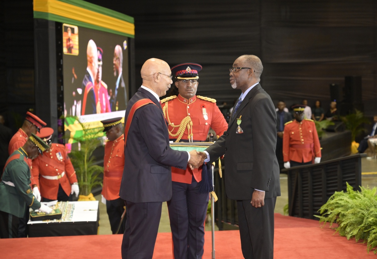 Governor-General, His Excellency the Most Hon. Sir Patrick Allen (left), presents the Order of Distinction in the Rank of Officer (OD) to Former Commissioner, Jamaica Fire Brigade, at the National Honours and Awards Ceremony, held on October 21 at the National Indoor Sports Centre, in Kingston.

